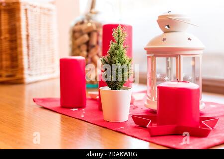 Vintage style ,Christmas table decoration.Cozy winter composition with candles, lantern on wooden table. Scandinavian hygge concept. home decoration Stock Photo
