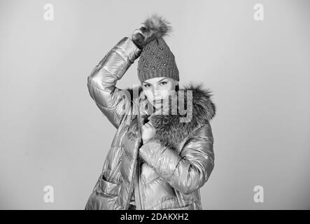 Fashion coat and hat. Faux fur. Warming up. Casual winter jacket slightly more stylish and have more comfort features such as larger hood fur trim on hood. Fashion girl winter clothes. Fashion trend. Stock Photo