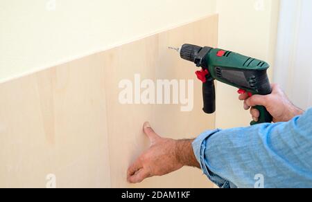 Human hand holding drill machine Stock Photo