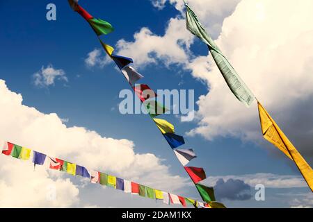 Traditional buddhist tibetan prayer flags against a blue sky Stock Photo