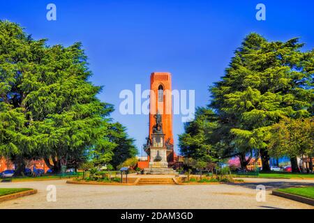 Public park in Bathurst city of regional Australia on a sunny day with statue and war memorial around bell tower - kings parade and George street. Stock Photo