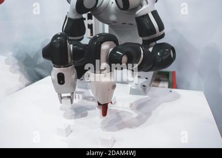 The robot adds cubes with letters Stock Photo