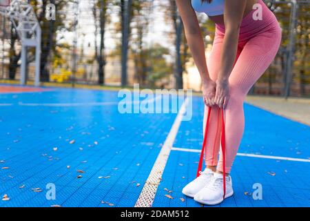 Sportswoman doing exercises with fitness resistance band Stock Photo