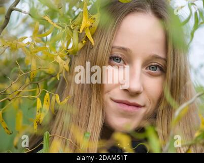 Portrait of a Young Beautiful Blonde Woman with Willow Leaves Stock Photo