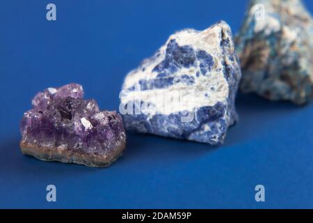 set of close up Natural minerals, precious stones on classic blue background. Use for jewelry. Space for text. Stock Photo