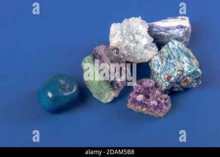 set of close up Natural minerals, precious stones on classic blue background. Use for jewelry. Space for text. Stock Photo