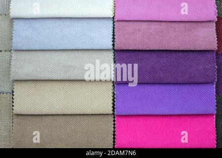Scraps of colored tissue close up. A set of colored samples of upholstery fabric for furniture. Catalog of cloth from matting fabric texture backgroun Stock Photo