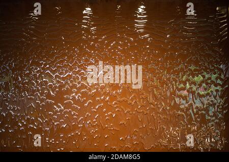 Liquid milk chocolate flowing wall with waves. Stock Photo