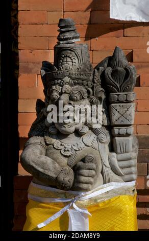 Rakasa - mythical Hindu demon-guardian with long teeth and large club at temple entrance, Ubud, Bali, Indonesia. Stock Photo