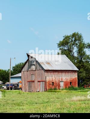 Old faded red wood barn in rural Kansas, USA. Stock Photo