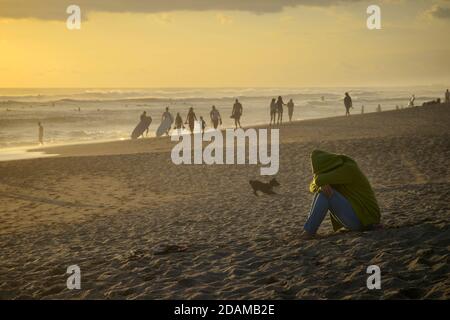 Beachgoers on Nelayan Beach at sunset, North of Kuta, Bali, Indonesia Stock Photo