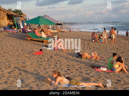 Beachgoers on Nelayan Beach at sunset, North of Kuta, Bali, Indonesia Stock Photo