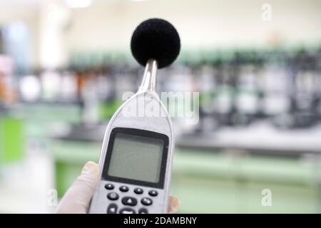 Scientist measuring the noise in a laboratory with a sound level meter. Stock Photo