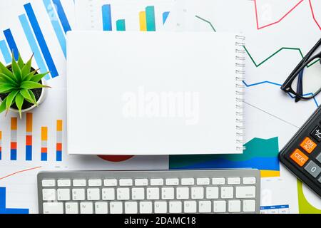 Notepad for notes copy space on charts and financial statements with keyboard. Stock Photo