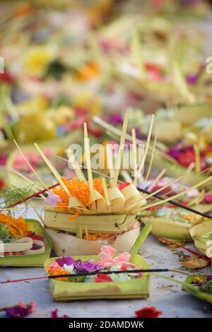 Balinese temple offering at Sakenan temple, Bali, Indonesia. Canang sari is one of the daily offerings made by Balinese Hindus. Stock Photo