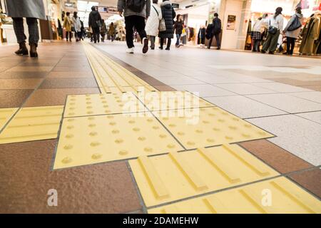 Indoor tactile paving foot path for blind and vision handicap Stock Photo