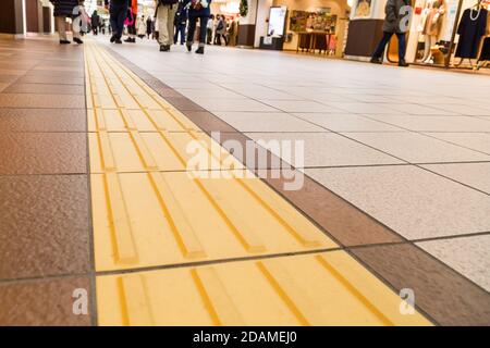 Indoor tactile paving foot path for blind and vision handicap Stock Photo