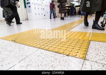 Indoor tactile paving foot path for blind and vision handicap Stock Photo