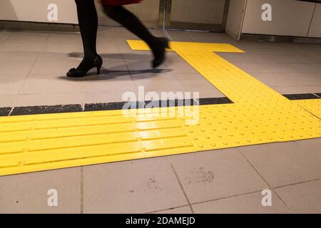 Indoor tactile paving foot path for blind and vision handicap Stock Photo