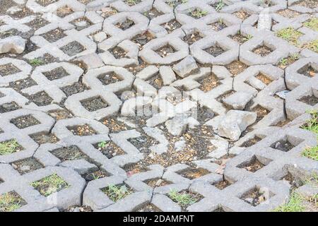Surface of a broken cement brick pavement for textural background Stock Photo