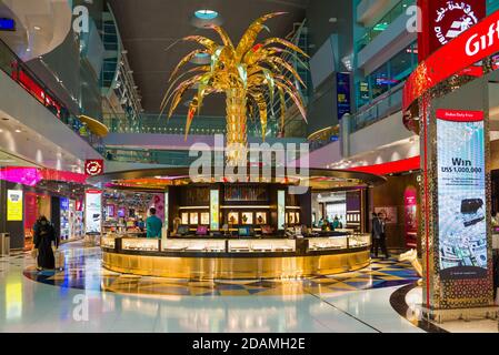 DUBAI, UAE - FEBRUARY 02, 2020: Golden Palm tree above the jewelry section of the Duty Free store in the transit area of Dubai Airport
