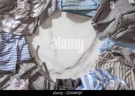Frame made of clothing as pyjamas, undergarments, garments on a white marble background. Stock Photo