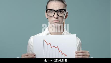 Businesswoman holding a negative financial chart, financial crisis and loss concept Stock Photo