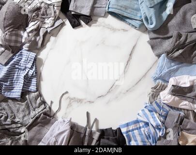 Frame made of clothing as pyjamas, undergarments, garments on a white marble background. Stock Photo