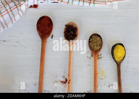 Various spices on wooden spoons. Food ingredients./ Assortment of colorful spices in the wooden spoons./ Stock Photo