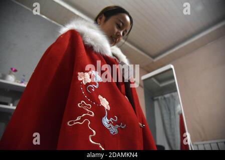 (201114) -- HEZE, Nov. 14, 2020 (Xinhua) -- Sun Yan, an online clothes store owner, tries the costume she designed in the fusion of the traditional clothing of the Han ethnic group that is generally called Hanfu, in Sunzhuang Village in Caoxian County of Heze City, east China's Shandong Province, Nov. 9, 2020. Sunzhuang Village thrives on e-commerce business. Among some 760 households in the village, more than 560 run online clothes stores on Taobao.com, Alibaba's main e-commerce site. The village's sales volume of costumes exceeded 200 million yuan (about 30.22 million U.S. dollars) in 2019. Stock Photo