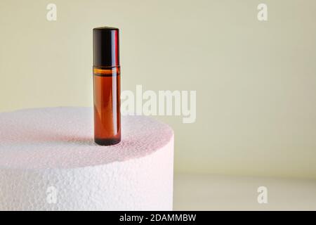 Dropper Bottle - Amber Glass for unlabelled perfume bottles on white podium. Stock Photo