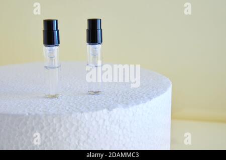 Dropper Bottle for perfume bottles without labels on a white podium. Stock Photo