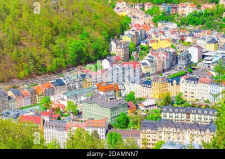 Karlovy Vary Carlsbad historical city centre top aerial view with colorful beautiful buildings, Slavkov Forest hills with green trees on slope, close-up, West Bohemia, Czech Republic Stock Photo