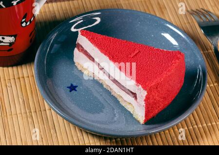 Raspberry holiday cheesecake Servings on a table with bamboo napkin Stock Photo