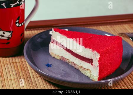 Raspberry holiday cheesecake Servings on a table with bamboo napkin Stock Photo