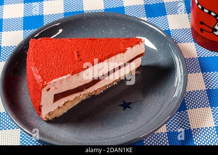 Raspberry holiday cheesecake Servings on a table with white blue  checkered tablecloth Stock Photo