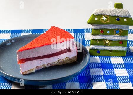 Raspberry holiday cheesecake Servings on a table with white blue  checkered tablecloth Stock Photo