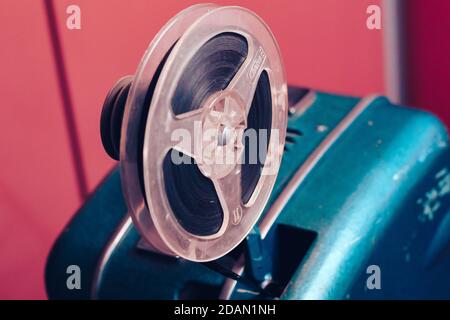 Old 8mm Film Projector over pink textured background. Retro style 60's banner concept Stock Photo