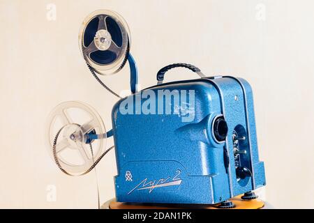 Old 8mm Film Projector over light textured background. Retro style 60's banner concept Stock Photo