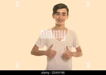Smiling teenage boy giving thumbs up Stock Photo - Alamy