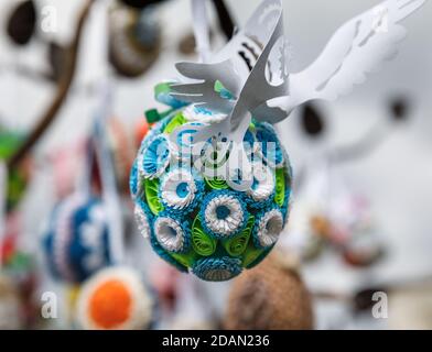 Folk art and festival of Easter Eggs. Easter holiday. Multicolored Easter eggs hanging on artificial trees Stock Photo