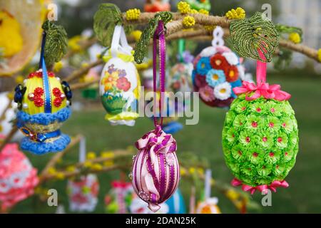 Folk art and festival of Easter Eggs. Easter holiday. Multicolored Easter eggs hanging on artificial trees Stock Photo