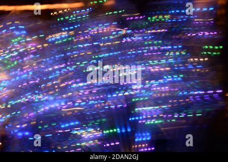 blurred multi colored neon lights at night with bright bokeh effects Stock Photo