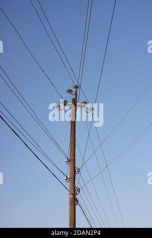 old wooden pillar with many wires blue sky background. Stock Photo