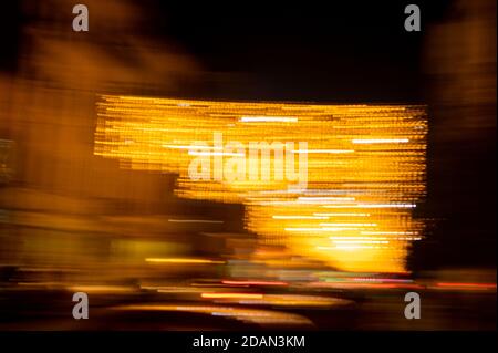 Speed of digital lights in motion. Bright orange neon glowing fast moving streams of light, along a trajectory. Fast energy flying wave line with flas Stock Photo