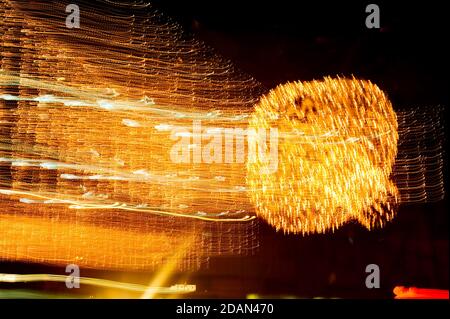 Speed of digital lights in motion. Bright orange neon glowing fast moving streams of light, along a trajectory. Fast energy flying wave line with flas Stock Photo
