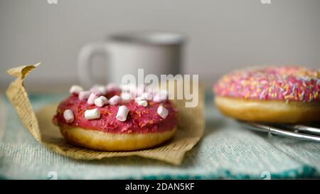 Close up view of delicious tasty glazed sprinkled with marshmallow donuts Stock Photo