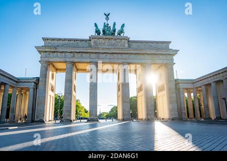 sun shining through brandenburg gate berlin germany Stock Photo