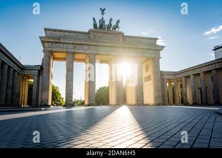 sun shining through brandenburg gate berlin germany Stock Photo