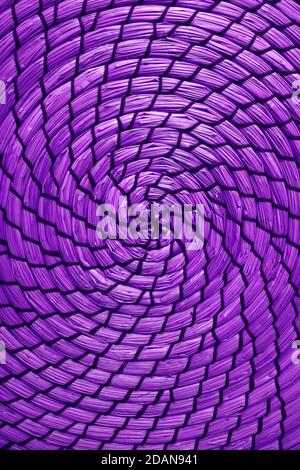 Spiral pattern of woven water hyacinth place mat in vivid purple color Stock Photo